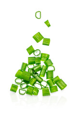 Freshly chopped green onion slices falling in mid-air isolated on white background, cooking and garnish ingredient concept