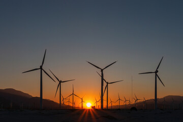 Scenic view of Palm Springs Windmills at Coachella Valley, California, USA at sunset against blue sky