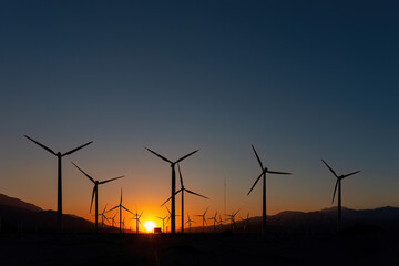 Scenic view of Palm Springs Windmills at Coachella Valley, California, USA at sunset against blue...