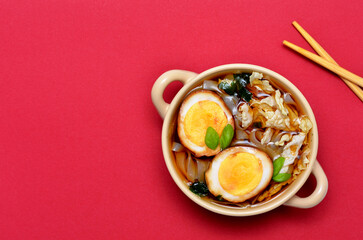 japanese cuisine soup ramen on a red background, flat lay