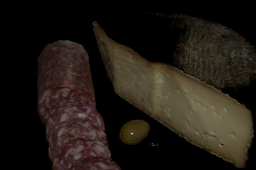 Large piece of Tomme de Savoie, cow's milk cheese, uncooked pressed cheese, with a gray, speckled...