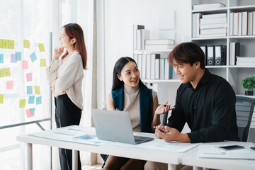 Asian Business Team Collaboration and Brainstorming Session in a Modern Office Space Enhancing Productivity Discussing Ideas and Planning Strategies Together