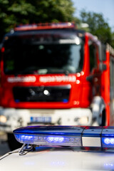 Emergency response vehicles at a fire scene during daylight