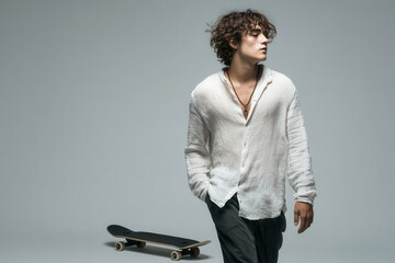 skateboarder in dynamic motion thoughtfully gazing into distance positioned on skateboard