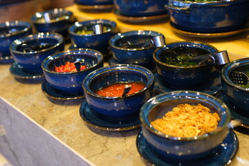 Lumber plate with assorted aromatic spiced falling on table and spilling mix on table