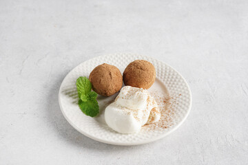 Tiramisu Mini Balls with whipped cream for dessert on the plate, copy space