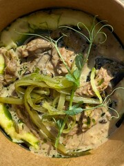 Creamy meat stew with herbs, mashed potatoes, green peppers, and microgreens in a bowl. Suitable...