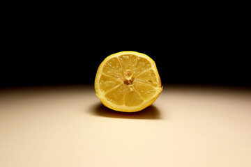Minimalist close up of sliced lemon half without juice on neutral background, isolated citrus fruit...