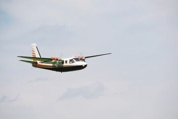 small twin-engine propeller plane flies in the air