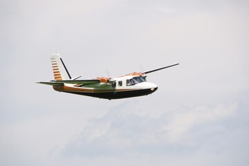 small twin-engine propeller plane flies in the air