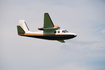 small twin-engine propeller plane flies in the air