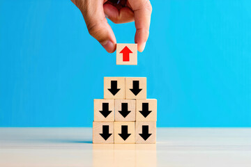 Elevate Your Business Strategy A Hand Placing a Red Up Arrow Block Atop a Pyramid of Downward Arrows Symbolizing Growth, Leadership, and Overcoming Challenges