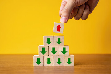 Reaching the Summit A Visual Metaphor for Success and Achievement with Wooden Blocks Displaying Arrows Pointing Upward and Downward on a Vibrant Yellow Surface