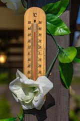 Wooden mercury thermometer showing very high temperature in summer on the front porch,