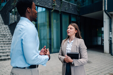 Businesspeople discussing work outside office building