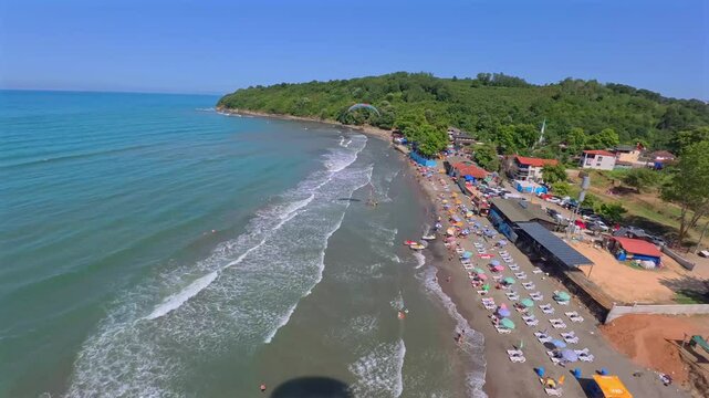 Aerial view of Karaburun Beach with paramotor, Turkey.