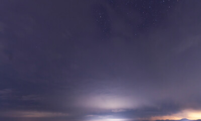 Beautiful night sky background, with long exposure clouds, starry sky.