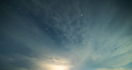 Beautiful night sky background, with long exposure clouds, starry sky.