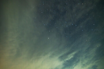 Beautiful night sky background, with long exposure clouds, starry sky.