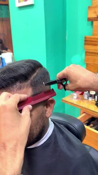 Hairdresser cutting hair in beauty salon