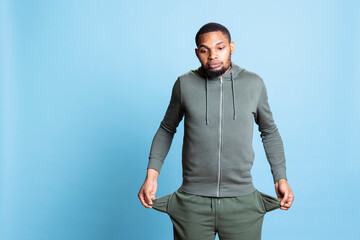 African american broke person with empty pockets being worried about unemployment, having no money...