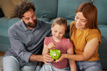 Family members gather in their cozy living room, celebrating a special moment as a girl excitedly...