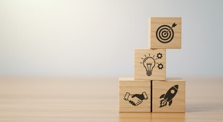 Wooden blocks stacked with business icons representing goals ideas partnership and launch.
