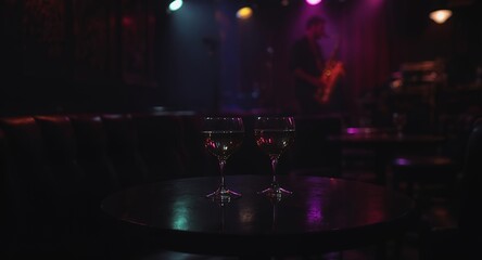 Two Wine Glasses on a Table in a Dark Lit Room