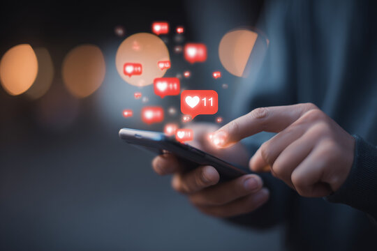 Social media: person's hands using smartphone with digital notifications - Powered by Adobe