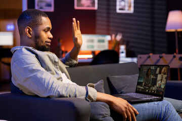 African american web user meeting with workmates on a video call remotely, ensuring a strong...