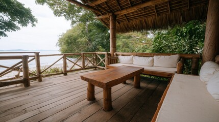 A tranquil outdoor living space, features a cozy seating area, wooden decking, a sturdy table, and panoramic views of the ocean. It's a relaxing and inviting atmosphere for rest and reflection.