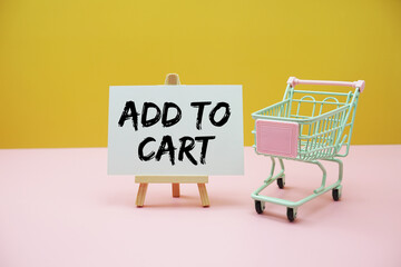 Add to Cart text with mini trolley shopping cart on pink and yellow background