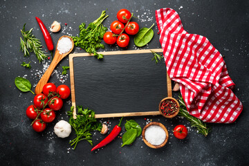 Food background on black. Herbs, spices and vegetables.