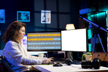 Photographer uses photo editing software on isolated screen PC display in studio. Freelancer uses...