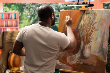 In a creative workshop, artist mixes pigments to achieve the perfect dye shade. Using professional...