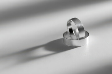 minimalist monochrome still life featuring single metallic ring on clean ultrabright background