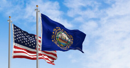 New Hampshire and National US flags waving in the wind on a clear day