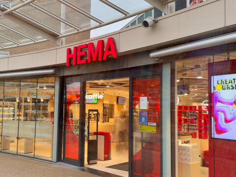 voorburg, netherlands - November 6 2024: Customers are exploring HEMA while the store lights illuminate the lively atmosphere of the shopping center during twilight.