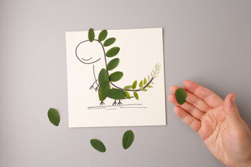 Step in process of making dinosaur from leaves for kids DIY craft, perfect for educational...