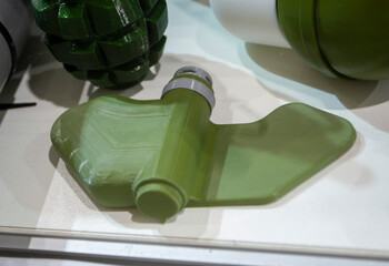 Mina Petal printed on 3D printer. Anti-personnel explosive mine created on 3D printer from molten plastic. Prototype of ammunition printed on 3D printer. Innovation modern new 3d printing technology