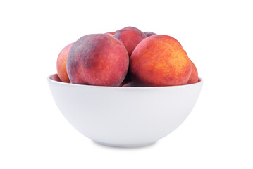 Fresh raw peaches in a white bowl on a white isolated background