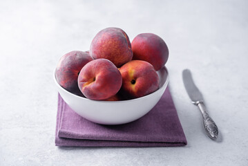 Fresh raw peaches on a white background