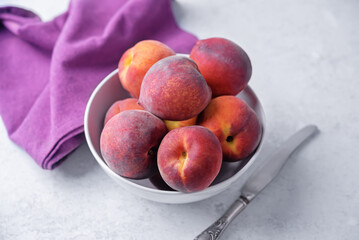Fresh raw peaches on a white background