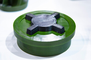 Anti-personnel high explosive mine printed on 3D printer. Mine created on 3D printer from molten plastic. Prototype of ammunition printed on 3D printer. Innovation modern new 3d printing technology