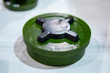 Anti-personnel high explosive mine printed on 3D printer. Mine created on 3D printer from molten plastic. Prototype of ammunition printed on 3D printer. Innovation modern new 3d printing technology