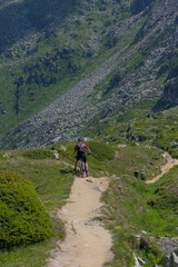 Experience mountain biking adventure! A cyclist conquers a rugged mountain trail under a bright...