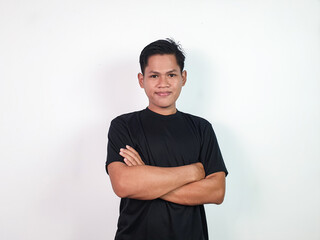 A confident Asian man stands against a plain white background, crossing his arms confidently. Ideal...
