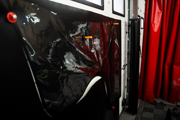 Manual Vinyl Wrap Cutting Using Physical Stencil. Vinyl wrap is manually cut using stencil over the...