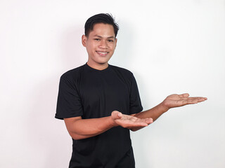 Smiling Man Pointing to Empty Space on White Background. Ideal for advertising, promotions, or...