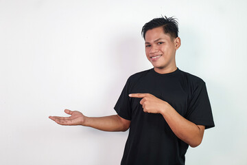 Smiling Man Pointing to Empty Space on White Background. Ideal for advertising, promotions, or...